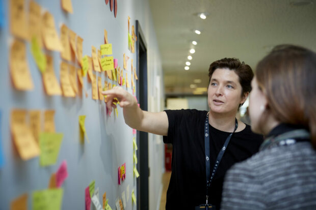 An image of Katy Arnold at a whiteboard in the workplace.