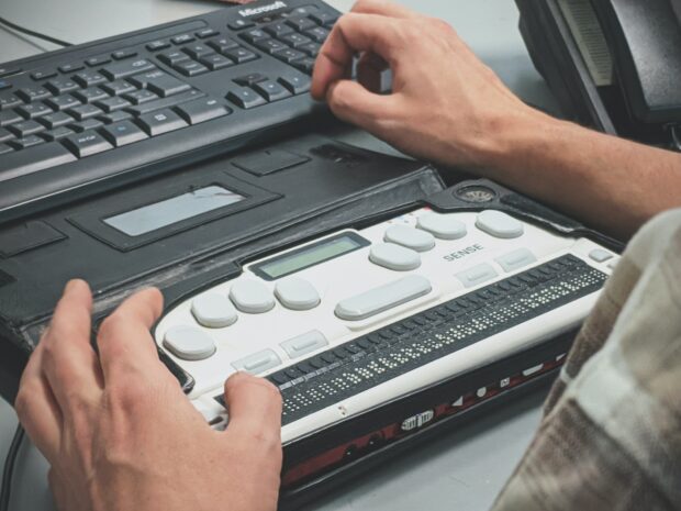 An image of a person using accessible computer hardware.