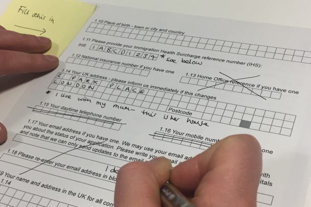 Picture of someone filling out a paper form