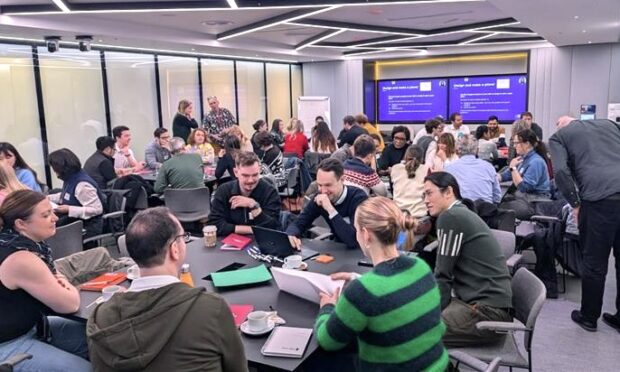 Members of Open Digital Planning at tables during an event