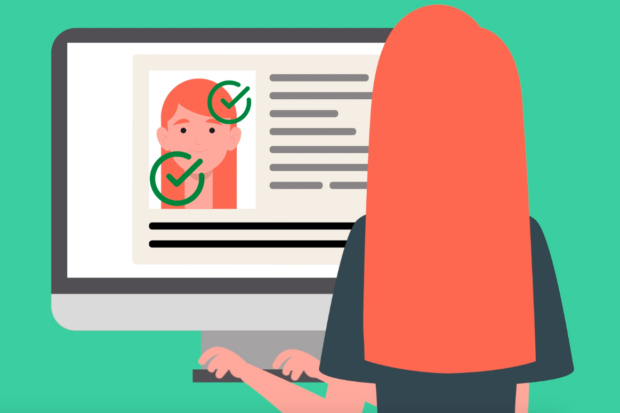 A woman is typing on a computer. The computer screen has a 'photo' of the woman with two green ticks on it to represent a positive digital identity check.