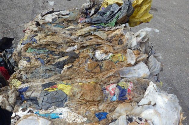 Heavily contaminated C&D film note presence of construction sand.