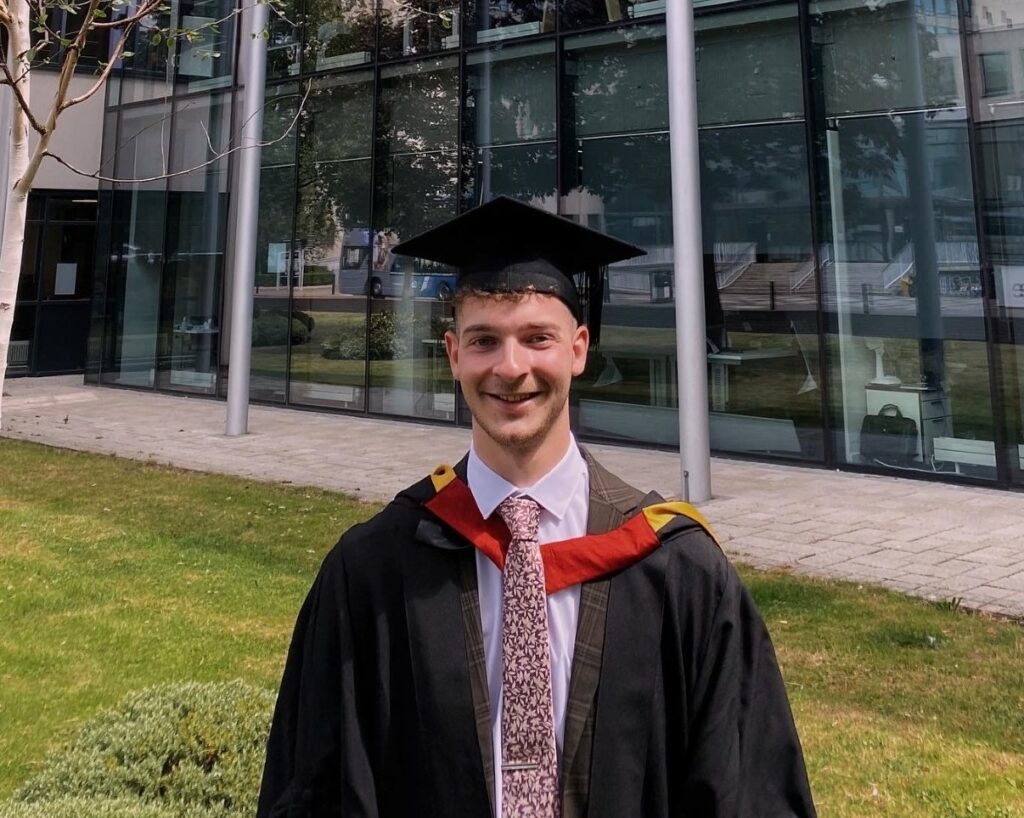 Matthew in his graduation gown and mortarboard