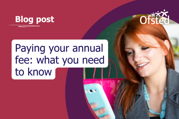 Text reads: Paying your annual fee, what you need to know. A young woman with red hair holds a smartphone in her hand with a blue phone case. She's looking at the phone screen with an interested and mild expression on her face.