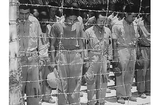 Japanese prisoners enclosed behind barbed wire