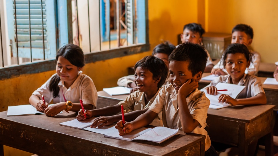 Cambodian primary learners of different genders in a classroom.