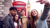 Group of young people taking a selfie, with a UK red phone box and Big Ben in the background.
