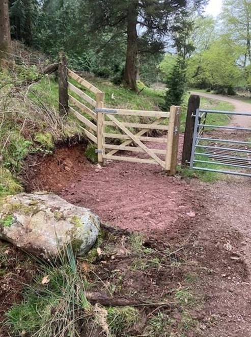 wooden gate with smooth soil underneath