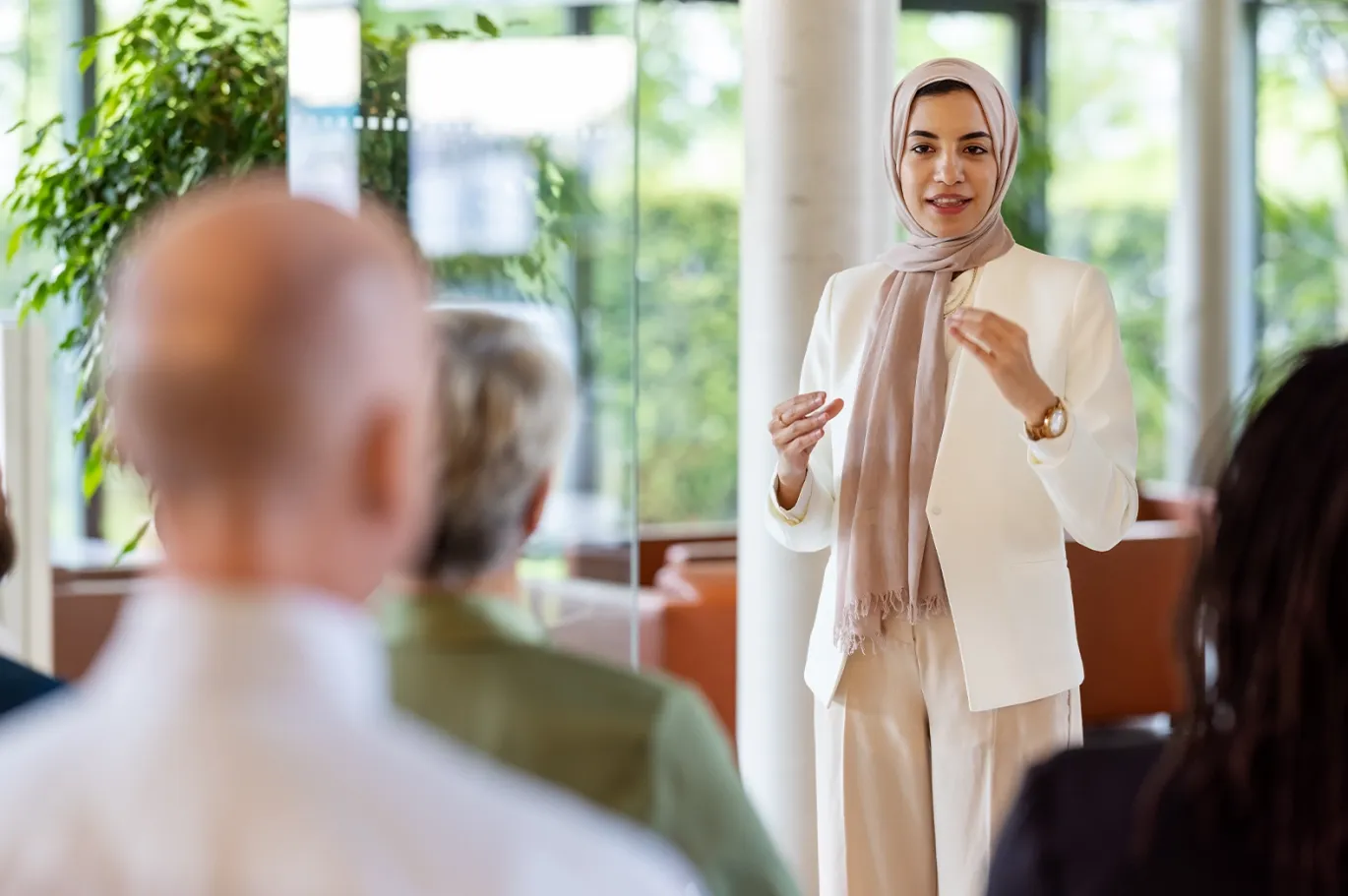 Woman giving an IELTS counseling or presentation session indoors.