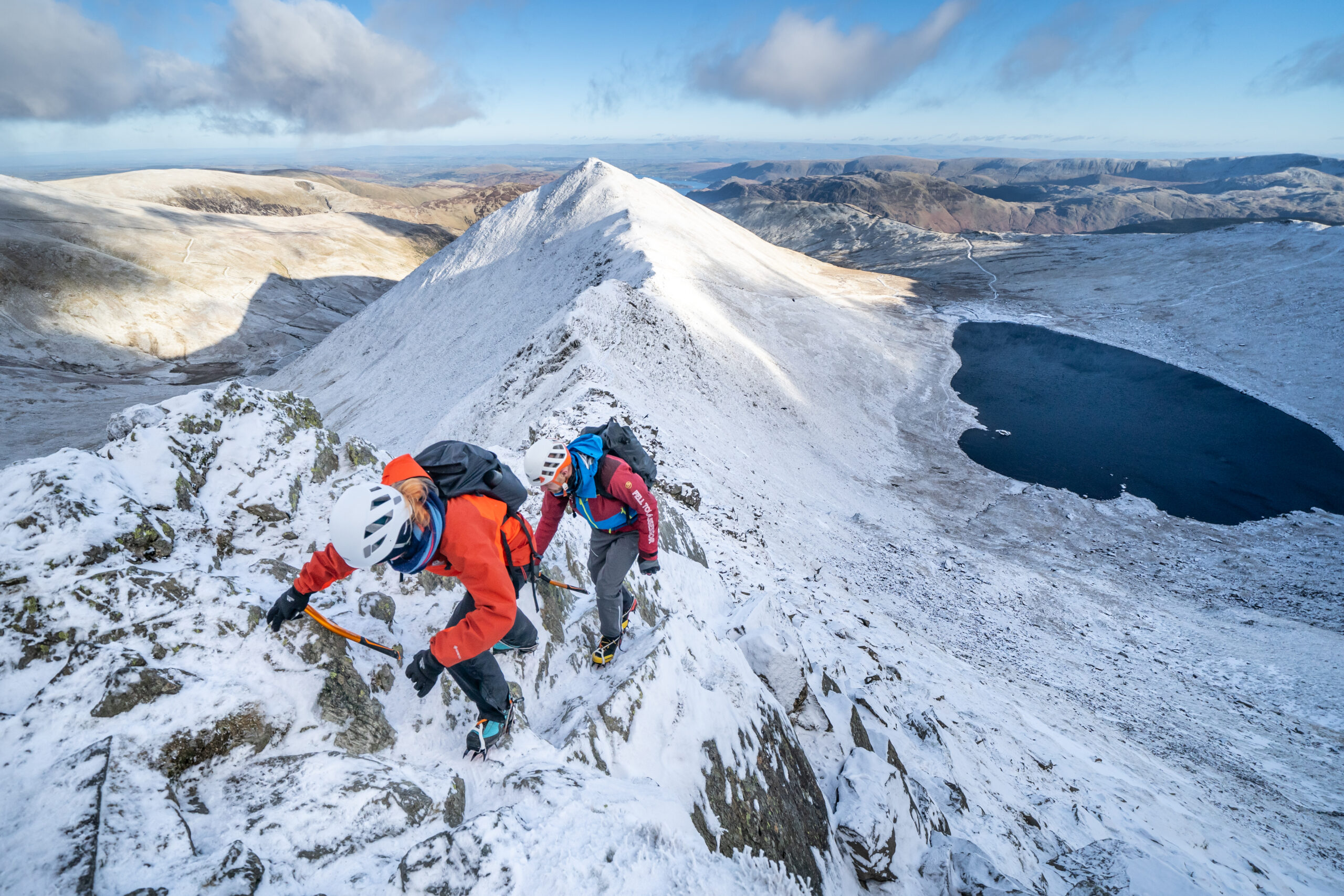 People climbing Helvellyn in the snow