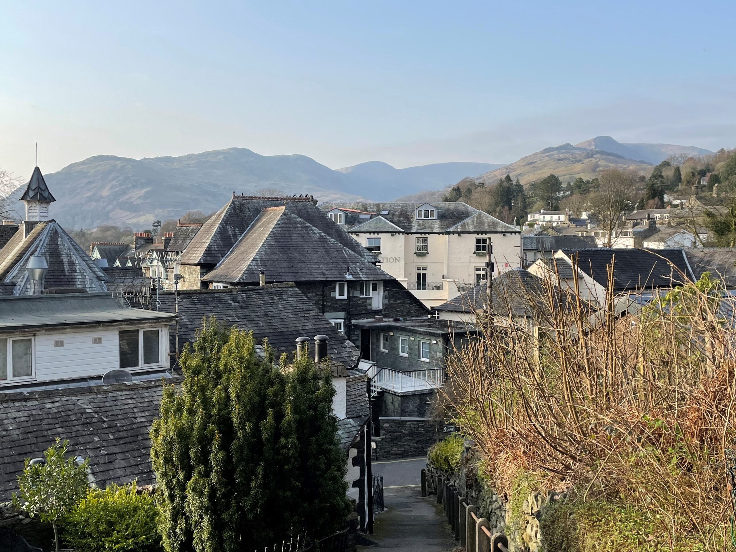 roof top view of slate houses in ambleside with fell backdrop