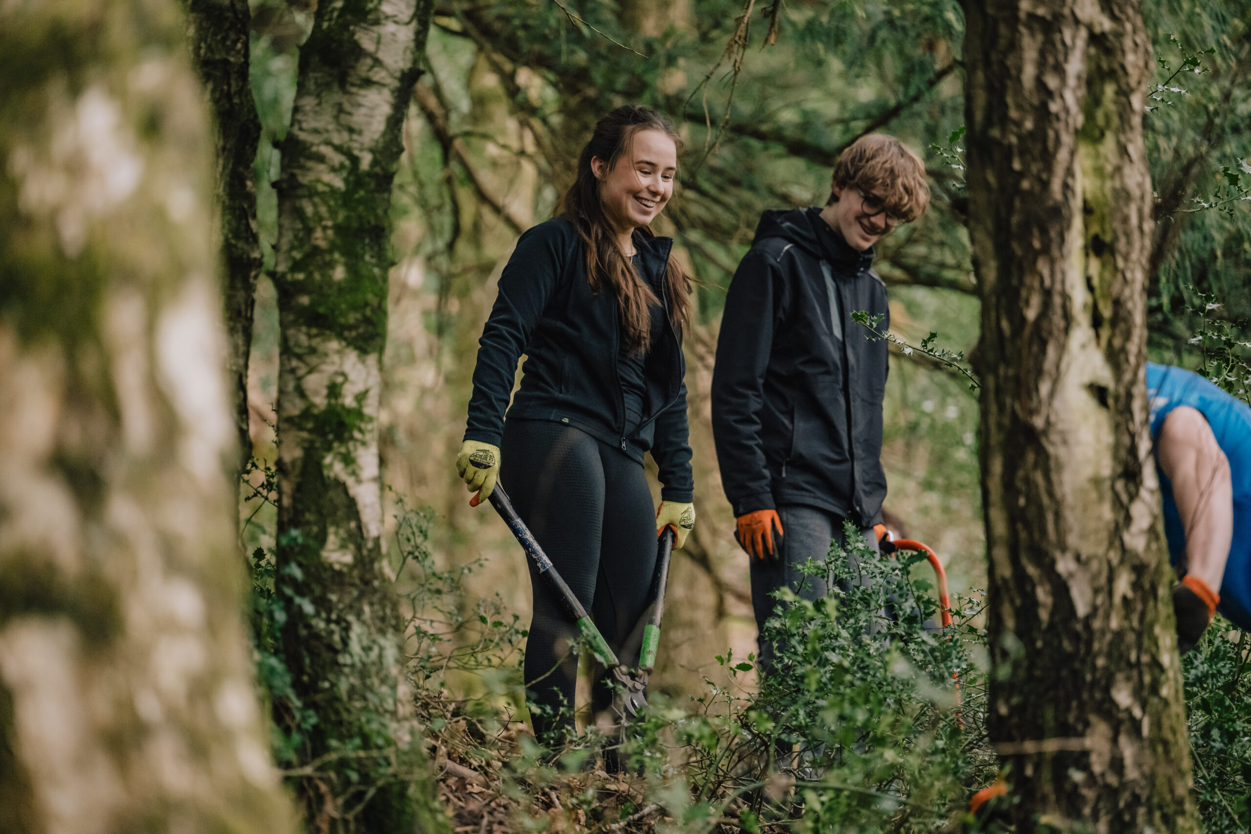 Young Ranger volunteers standing in woodland
