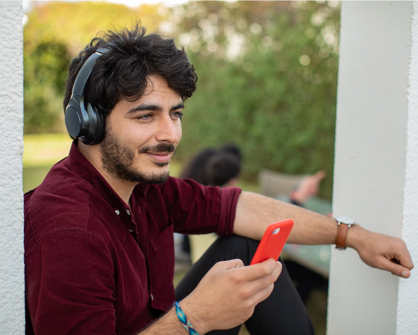 young-man-headphones-phone-outdoors