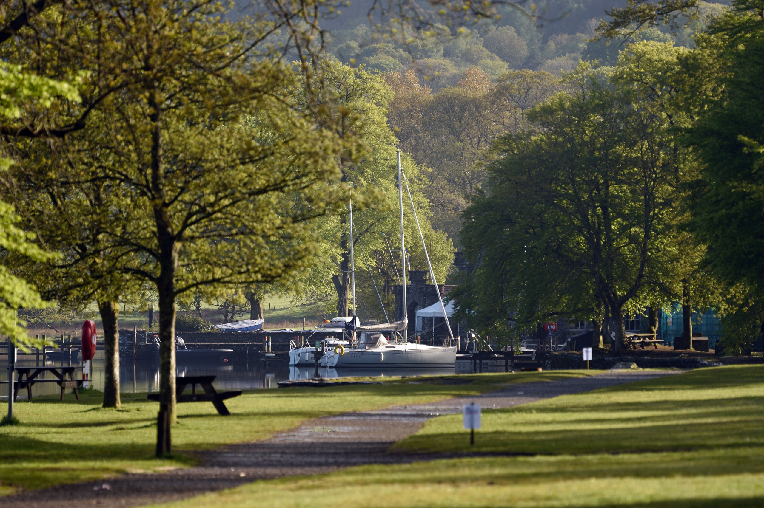 fell foot park. quiet grass field, green trees, sail boats moored