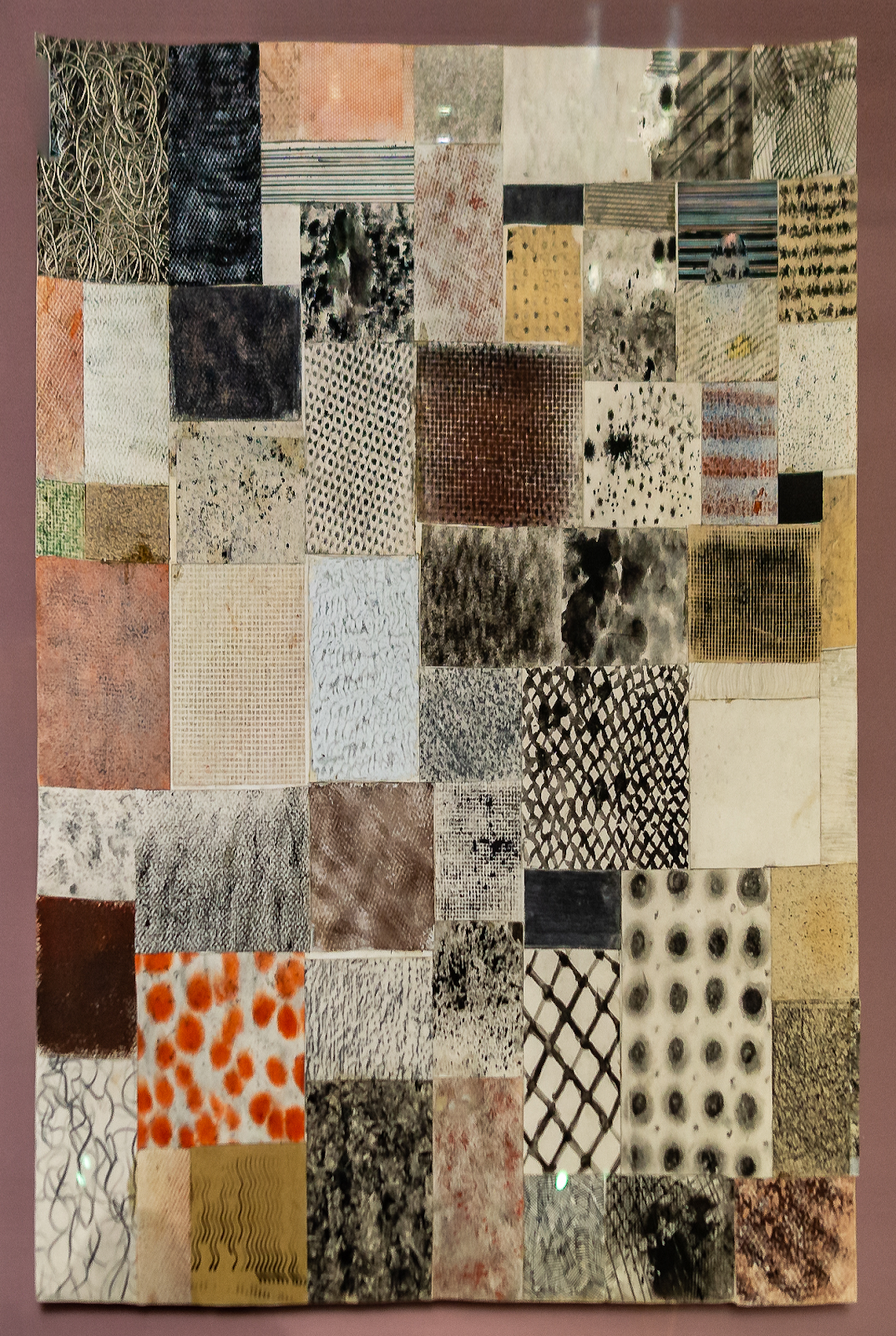 "Study on Texture," a collage of textured squares, showcasing various patterns and materials as part of a preliminary course by Johannes Itten. Each square features unique designs, including grids, dots, lines, and organic forms, highlighting Itten's exploration of tactile and visual textures for artistic study and sensory engagement.