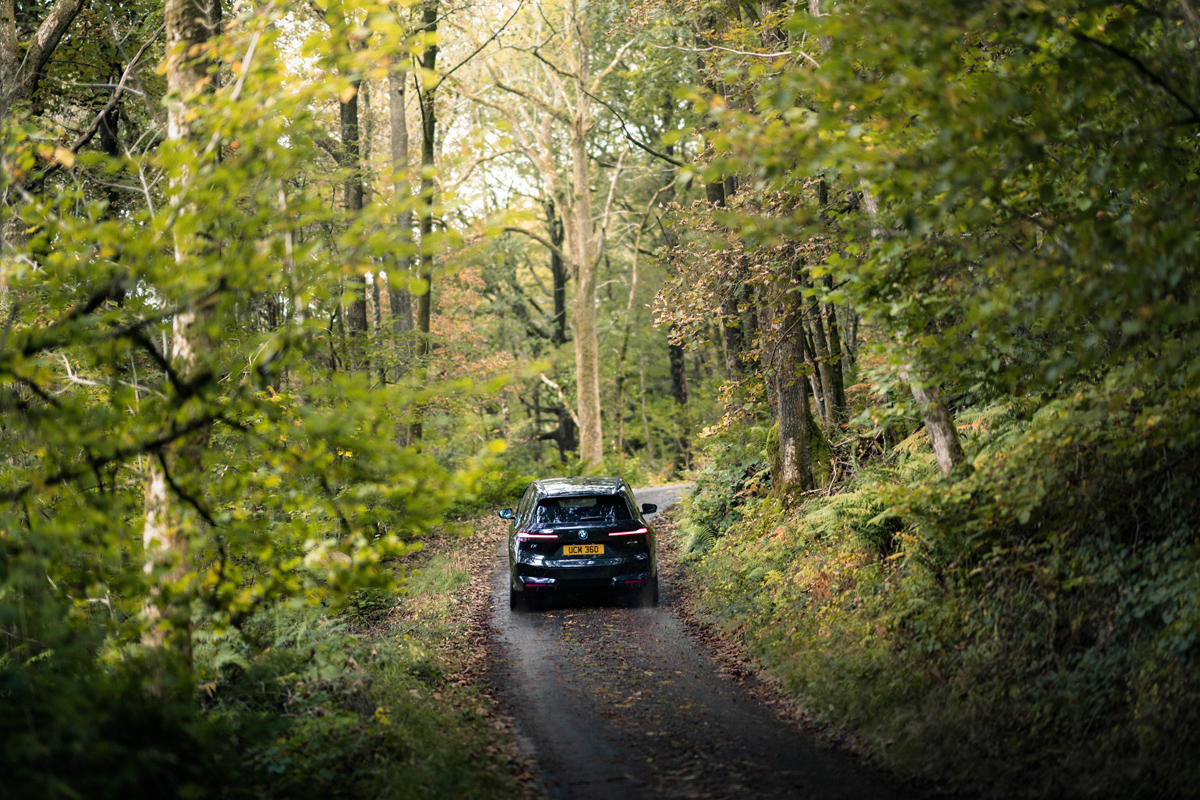 BMW are partnering with National Parks UK BMW EV drives down a country lane