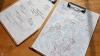 Clipboards holding copies of the worksheet used in a workshop exploring perceptions of the Arctic