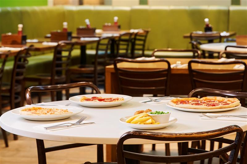 Four dishes are served on a round table in the resturant