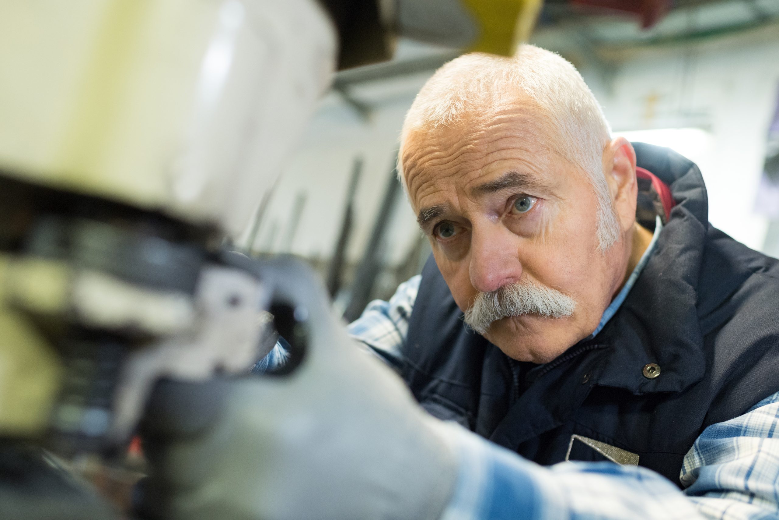 Older man working in an industrial factory. Links to Finding work at 50 plus - what are the options?