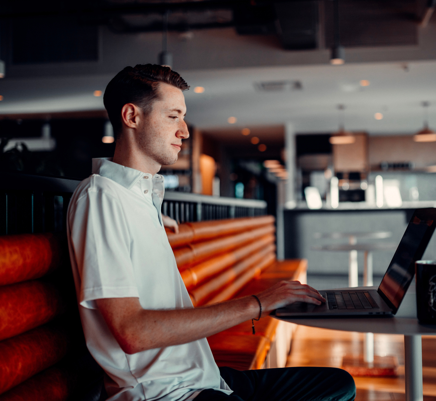 Man using laptop in cafe