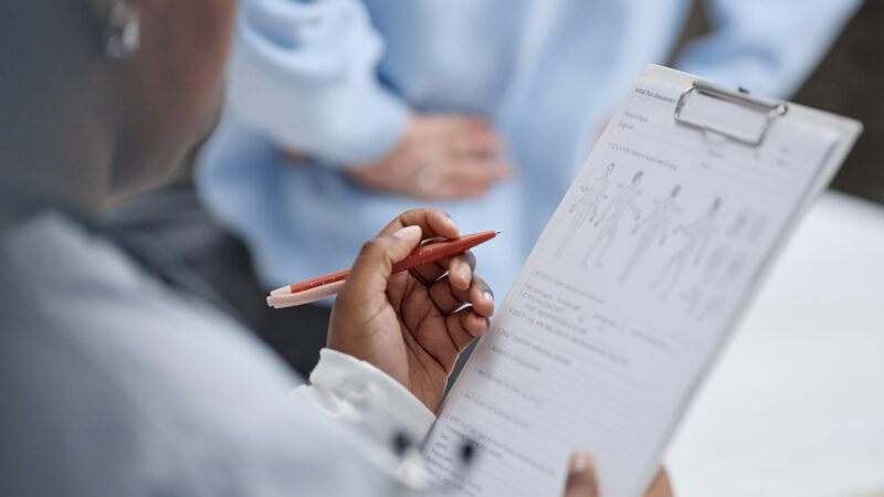 A clinician assessing a veteran in Scotland for a physical injury.