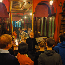 A VA talking to a tour group at the North end of the Library-Dining Room.