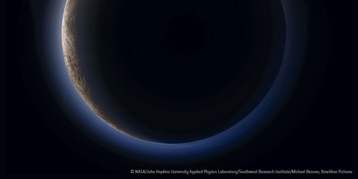 Photo of Pluto silhouetted against the Sun, surrounded by a blue atmosphere