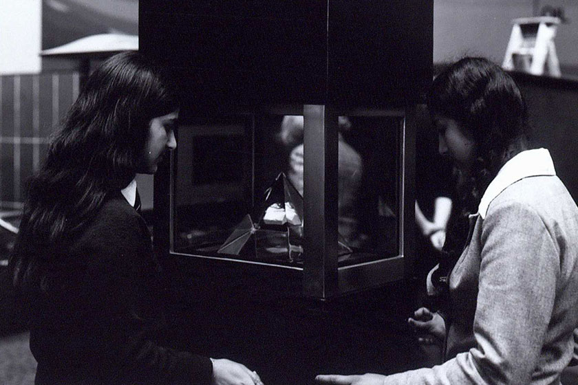 Visitors admiring a piece of the Moon collected by Apollo 16.