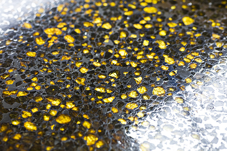 Light shining through the green-yellow crystals in the Imilac meteorite.  