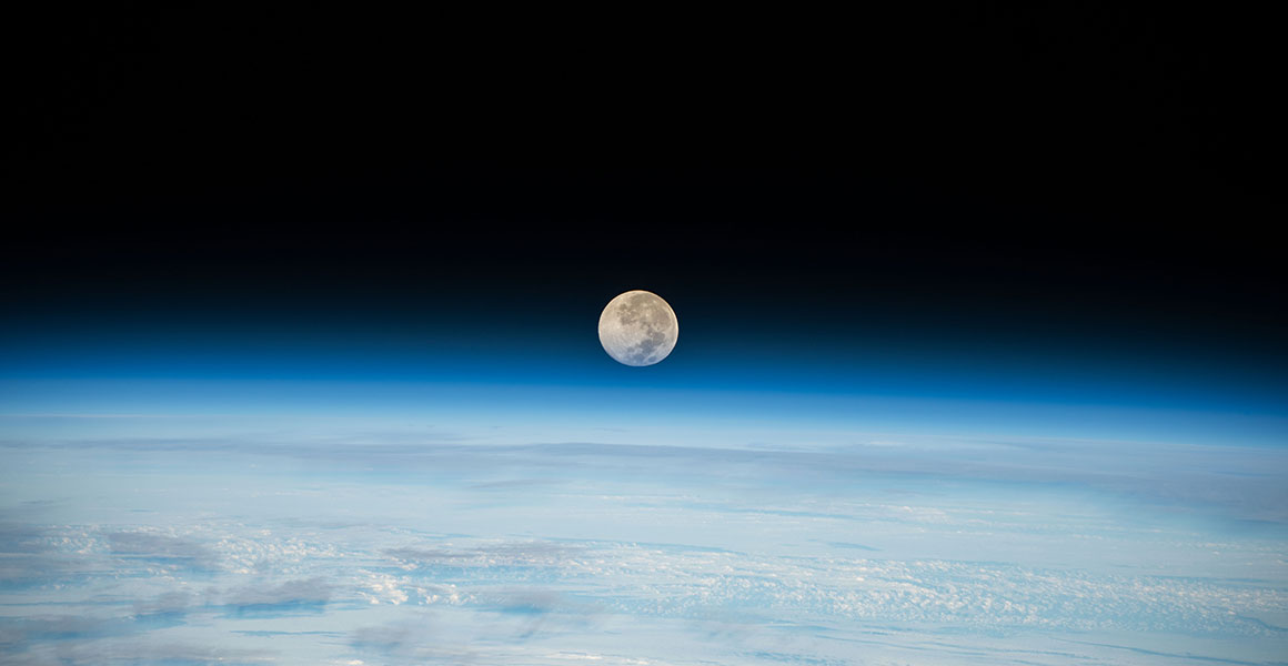 The Moon setting behind Earth's horizon