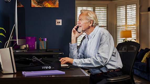 Man in home office on laptop