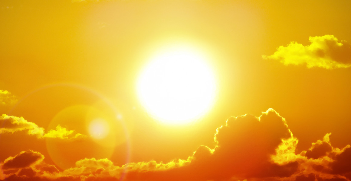 A yellow sun in an orange sky