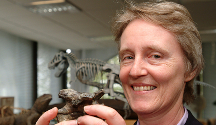 Dr Angela Milner holding a small fossil