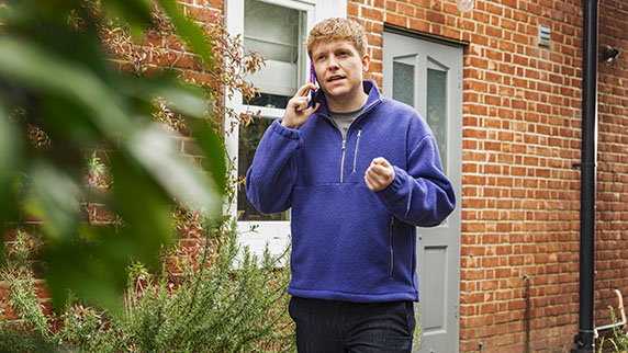 Young man on phone chatting outside