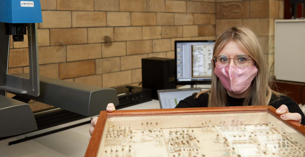 A digitiser moves a box of pinned insects towards a camera for digitisation