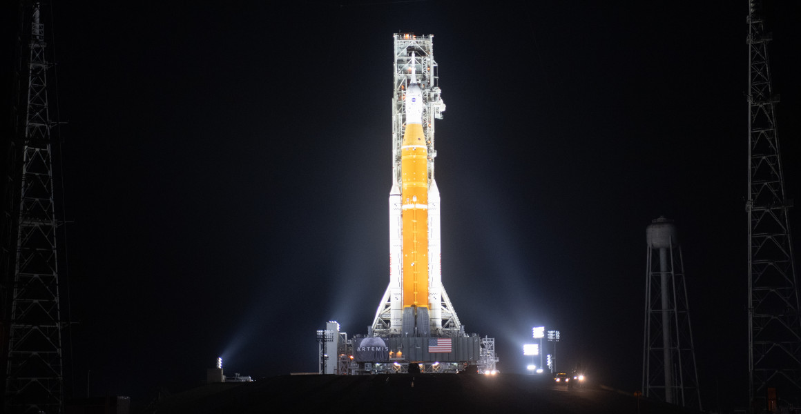 The SLS lit up against the night sky on the launch pad
