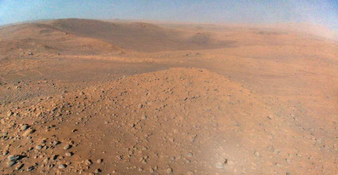 An airborne view of the Martian landscape from the Ingenuity helicopter.