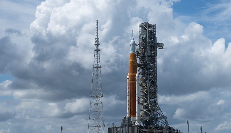The SLS on the lauch pad in Florida with clouds in the background. 