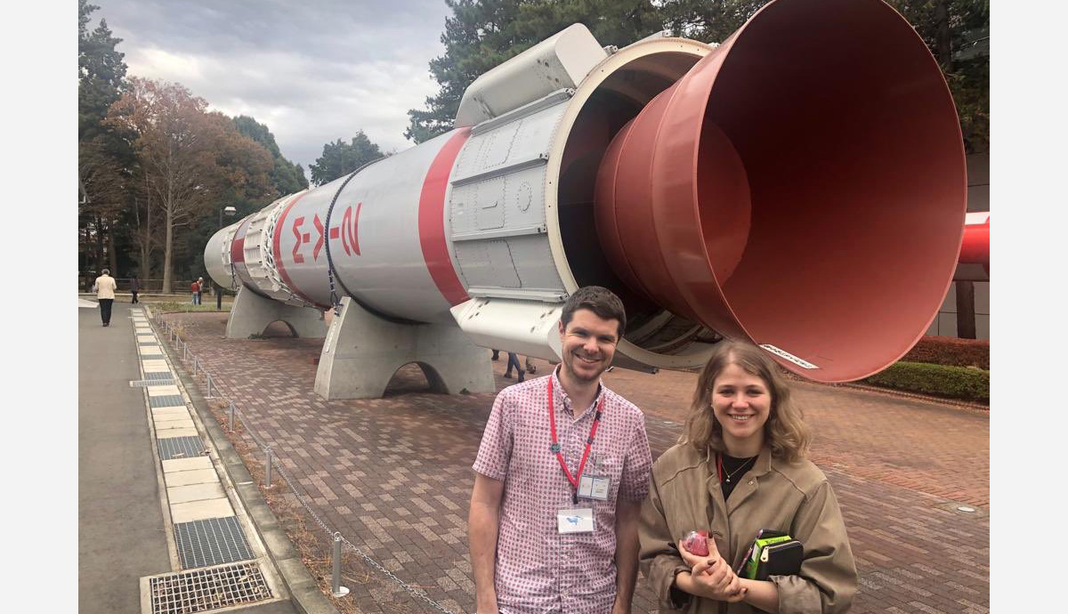 Dr Helena Bates and her PhD supervisor in front of a model of a rocket. 