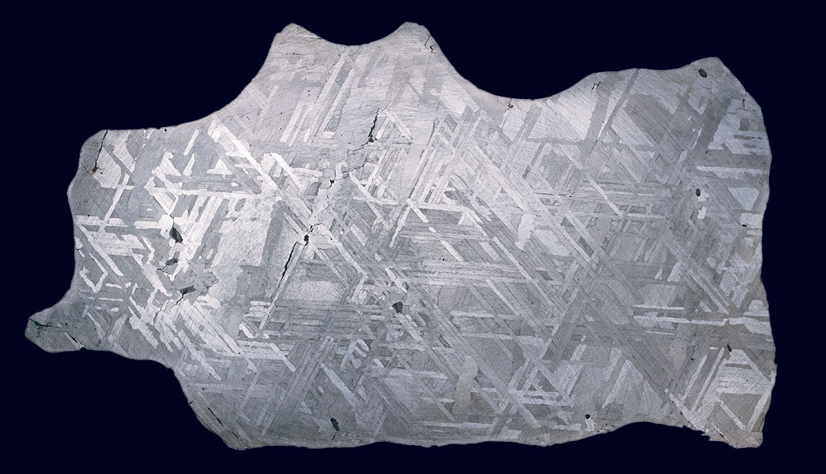 A metal meteorite with a criss-cross patter across its surface