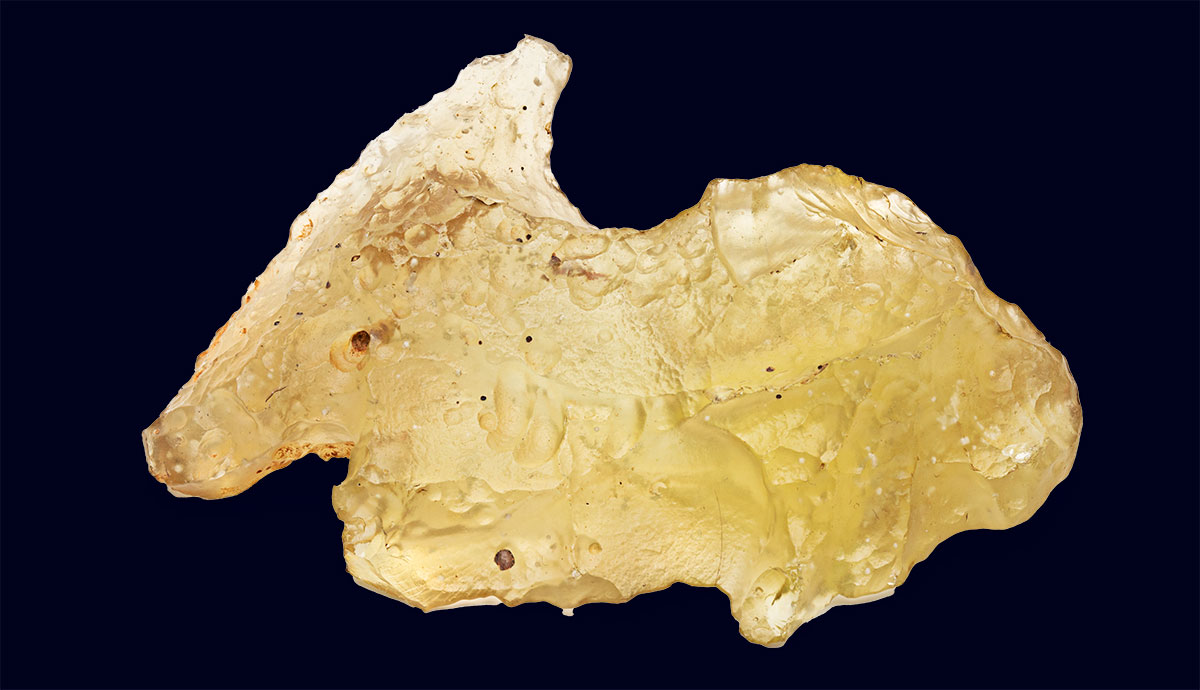 A translucent shard of amber-coloured desert glass