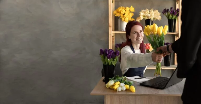 Man buys a beautiful bouquet of tulip flowers in a flower shop.