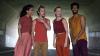 Four dancers wearing colourful clothing 