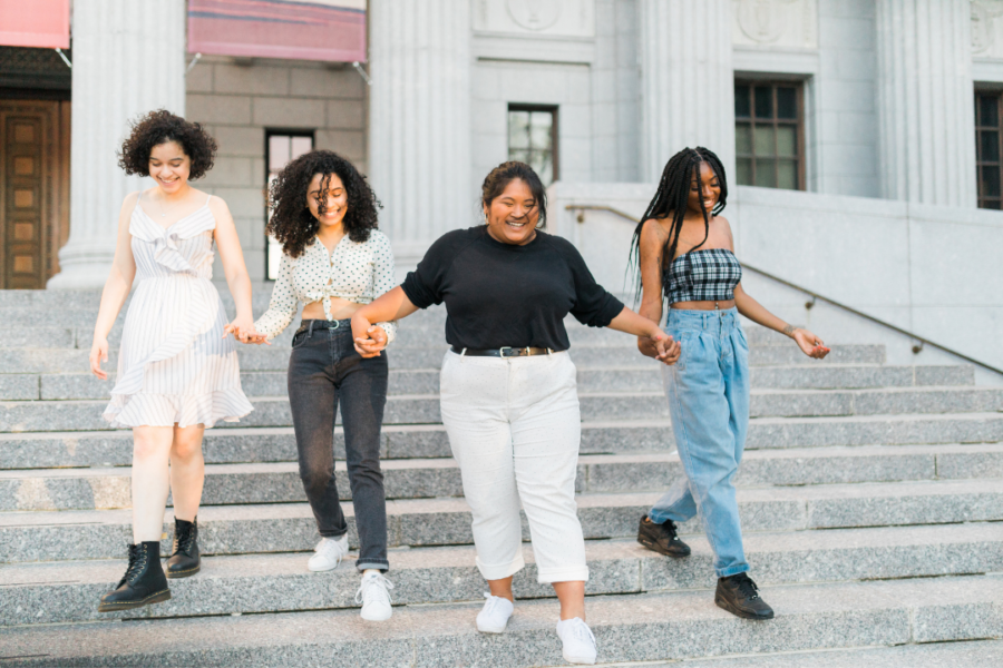 Four young women holding hands