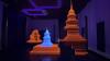 Three sculptures, two bright orange and one blue, in a dark blue room.