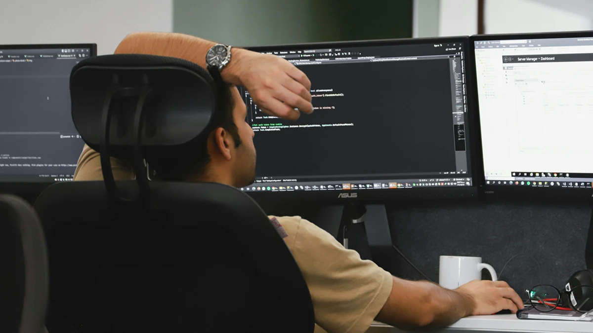 software developer sitting at desk writing code