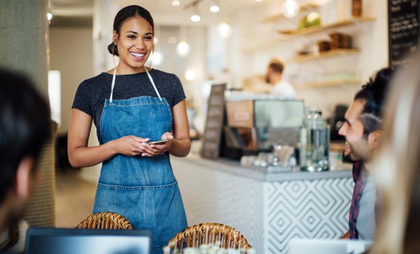 A server in a coffee shop taking an order