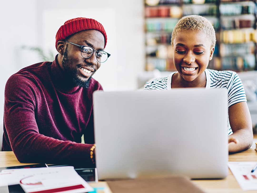 Man and woman sitting at a laptop