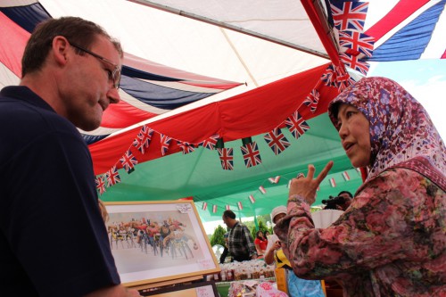 Showing HRH Princess Masnah one of the Raffle prizes from our Spirit of the Games Art Competition