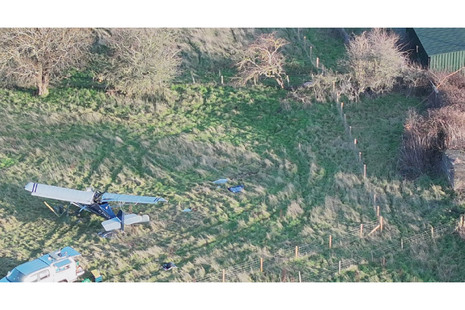 Photograph of G-CMAX final resting position – note tow rope trailing over foliage in the right of the image